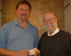 President Bob Garfinkel receives a grant from Mark Kanz of Dominion Energy